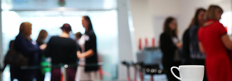 Coffee cup on a table in a conference room, ready for a productive meeting