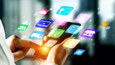 Person using a smartphone with colorful app icons floating above.