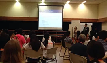 People attending a presentation in a conference room.