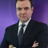 Man in a suit with a purple background.