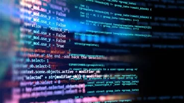 Close-up of colorful computer code lines on a black screen.